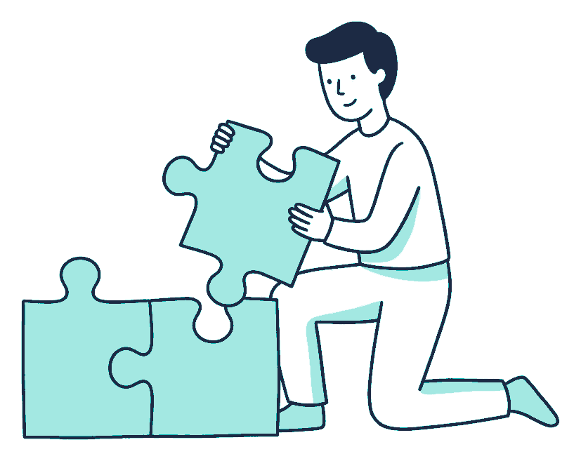 A person kneels on the floor fitting a third large jigsaw piece between two already joined pieces