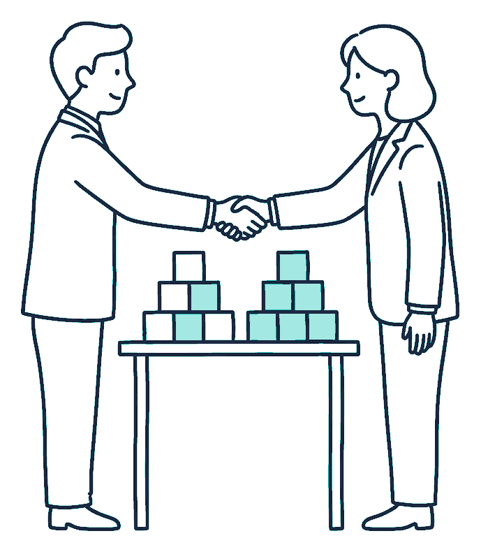 Two business partners shake hands over a table where a stack of blocks has been split into two piles