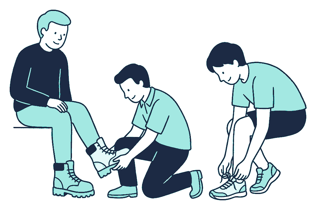 An assistant fits a heavy work boot onto one seated customer while another customer laces a light running shoe