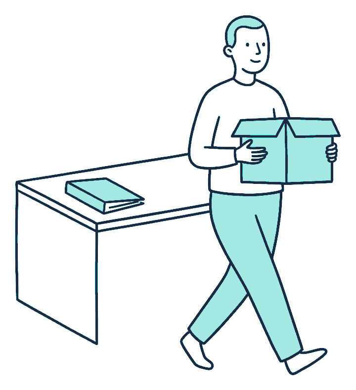 A worker walks away from an office desk carrying a cardboard box, leaving a lone document folder behind on the desktop