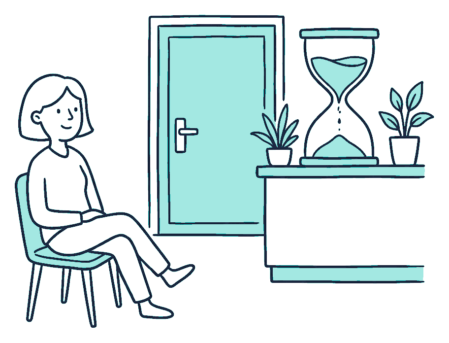 A person waits in a chair beside a clinic door, watching a big hourglass on the reception counter with most sand still to fall