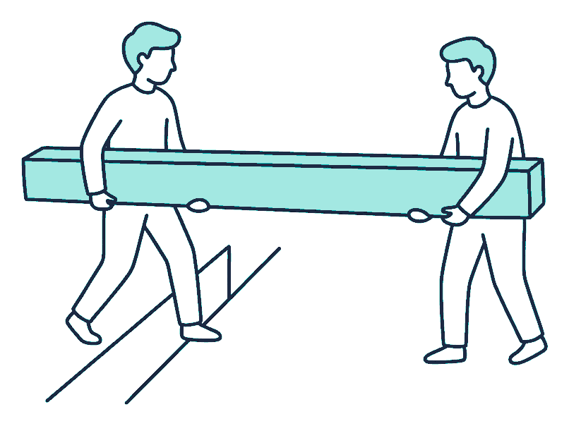 Two workers carry a long heavy beam together, one at each end, stepping over a gap in the ground