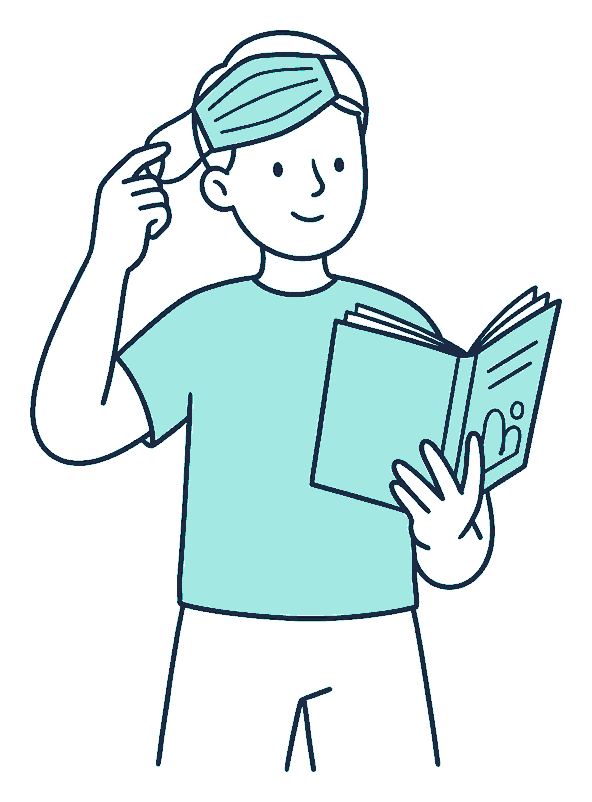 A person lifts a face mask off with one hand while reading an open policy booklet in the other