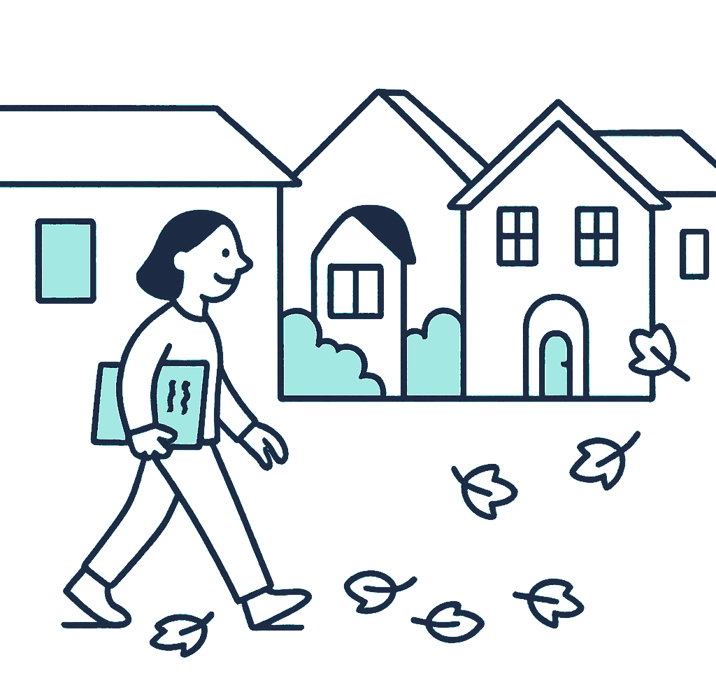 A person walks along a footpath past a row of villas, carrying a folder under one arm after a specialist appointment, autumn leaves underfoot
