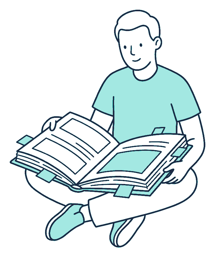 A person sits cross-legged on the floor with an oversized open book on their knees, tabbed pages sticking out of the edges