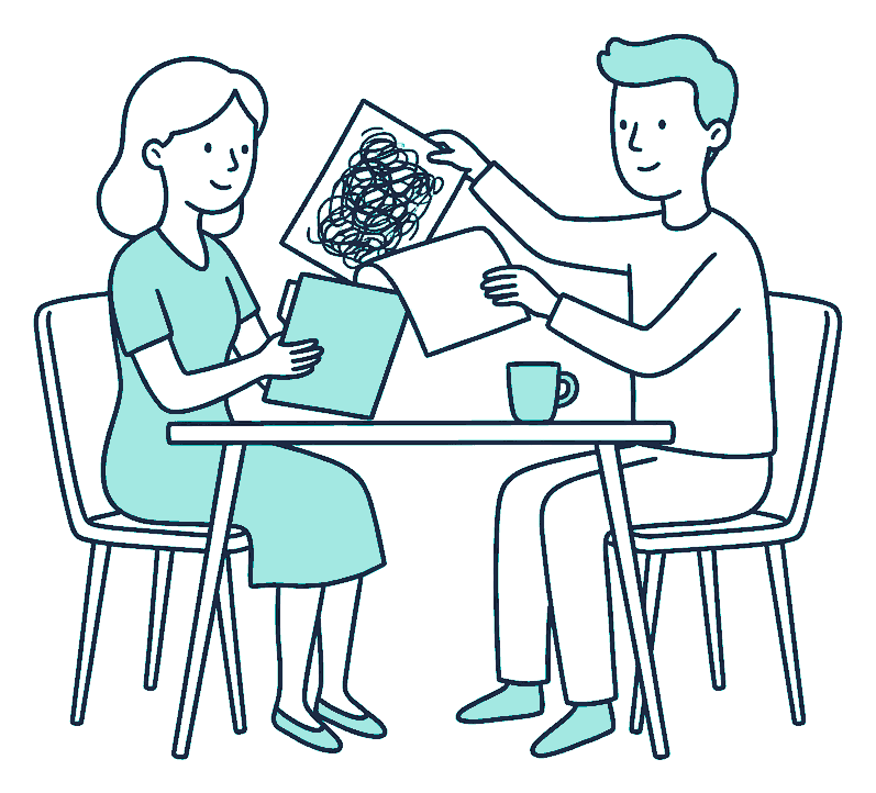 A newly married couple at a table replace a scribble-covered page in a folder with a fresh one