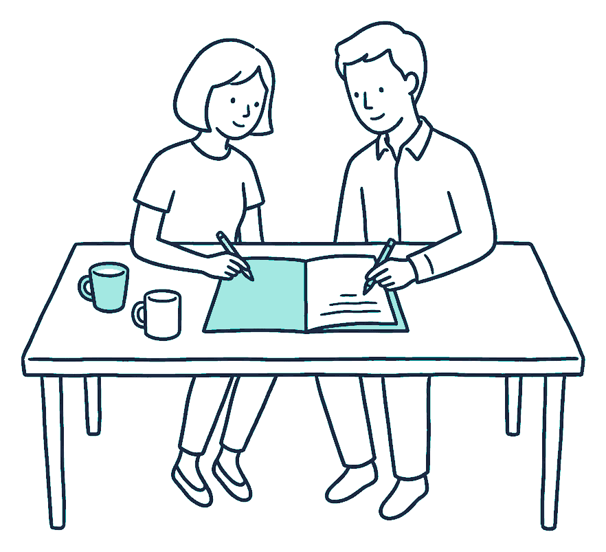Two people sit at a kitchen table leaning over one shared open folder, each holding a pen, two mugs beside them