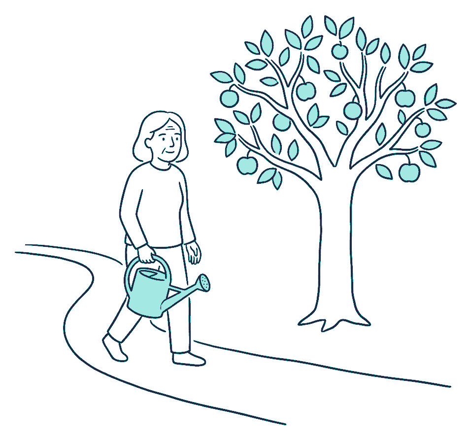 An older woman walks a long garden path with a watering can, passing a mature fruit tree