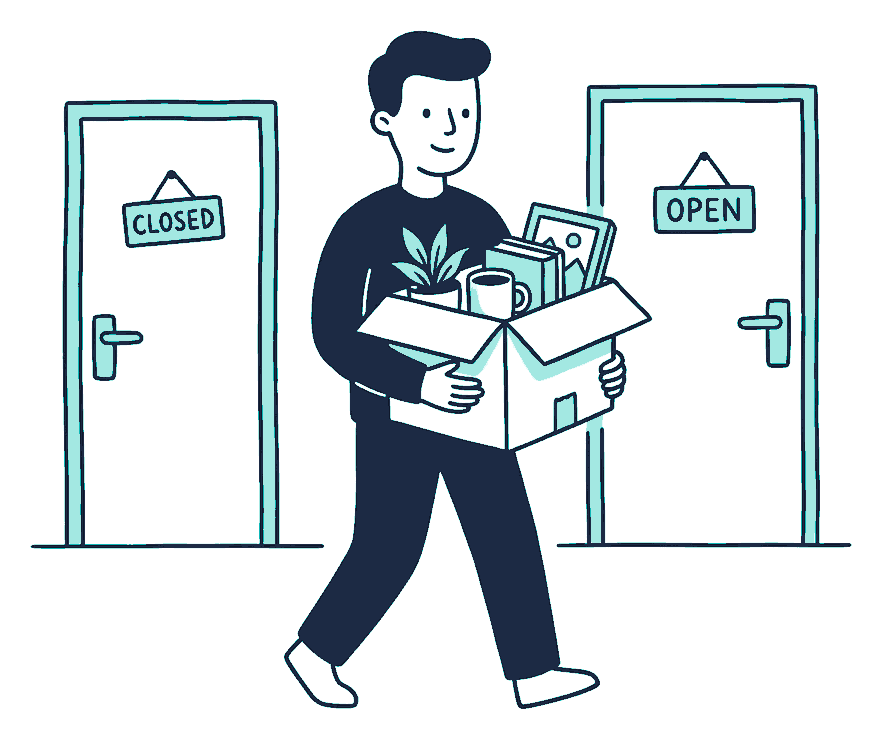 A worker carries a cardboard box of desk belongings out one office door toward another