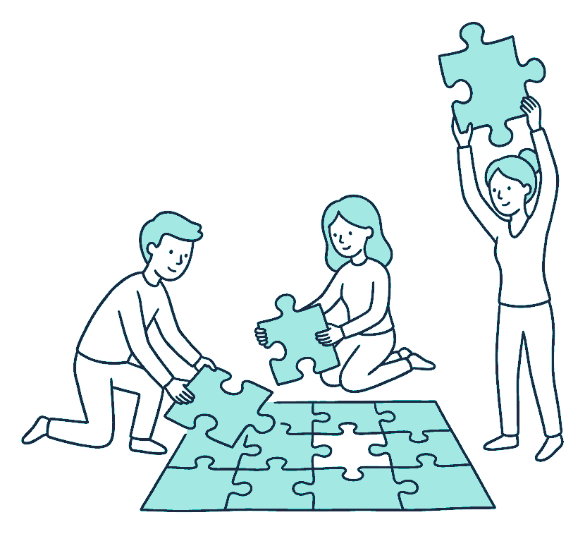 Two people press large jigsaw pieces together on a rug, the final piece held above the empty gap
