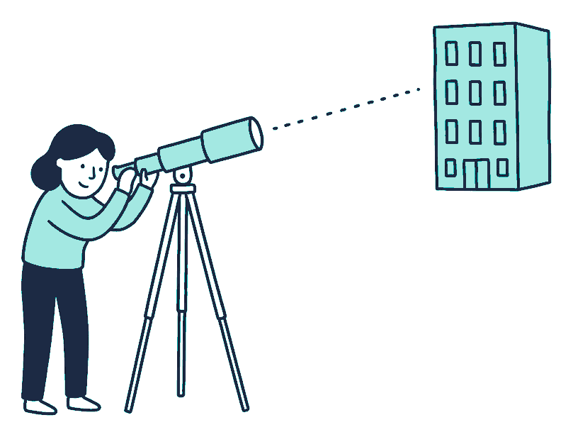 A person looks through a telescope on a tripod, aimed at a plain distant office block