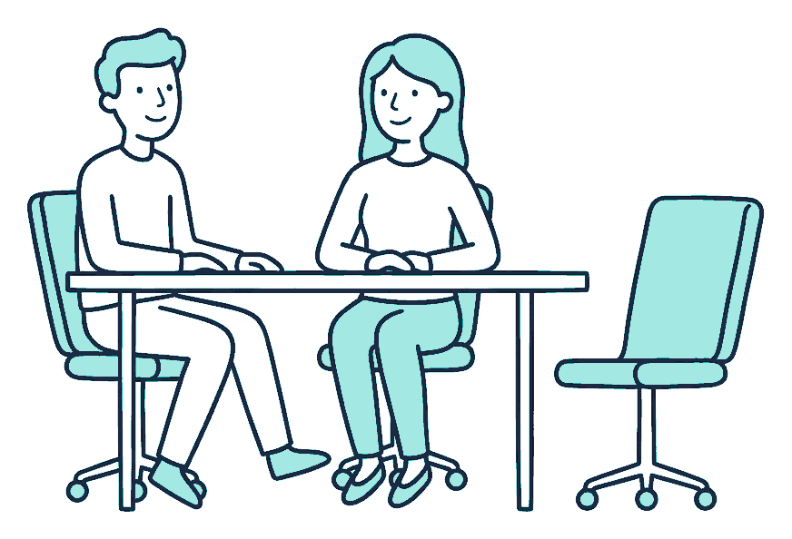 Two colleagues sit at a meeting table beside one empty rolling office chair pushed back from the table