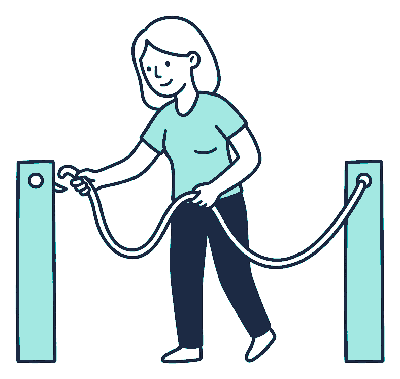A woman unhooks a rope from one anchor post and loops it onto a second post nearby
