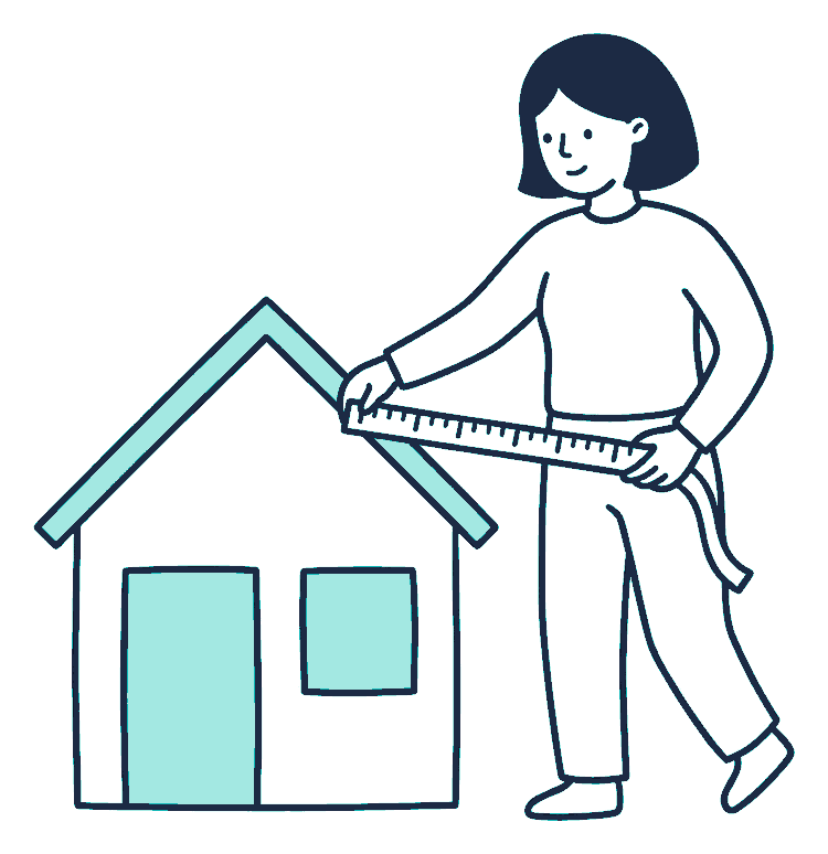 A person stretches a measuring tape across the front of a small house, reading the measurement