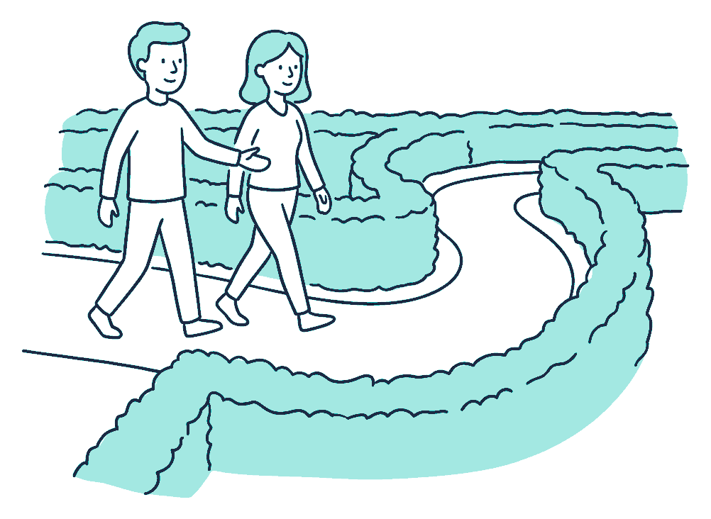 An adviser guides a client along a clear path through a low hedge maze, gesturing towards the way ahead