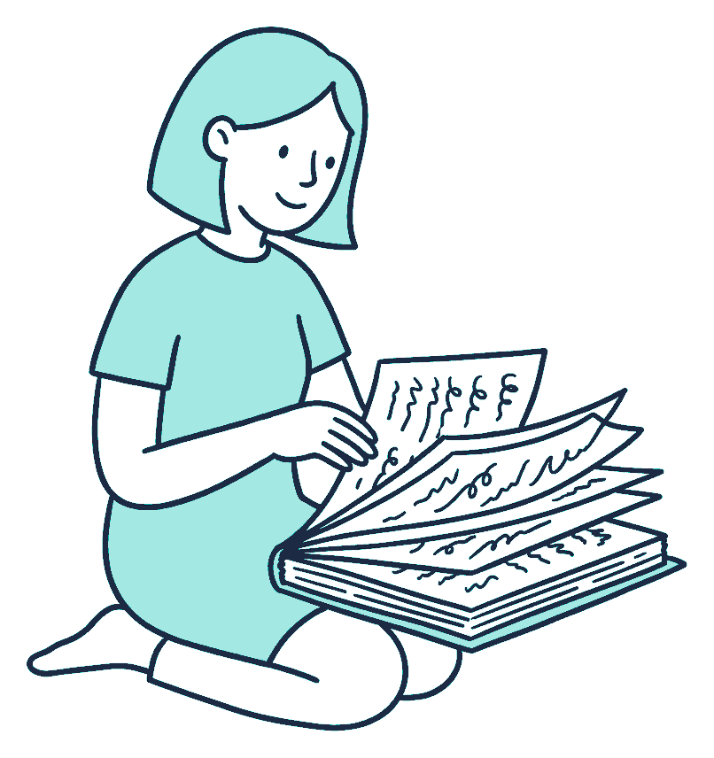 Kneeling on the floor, a woman flips through a thick booklet covered in squiggly scribble lines