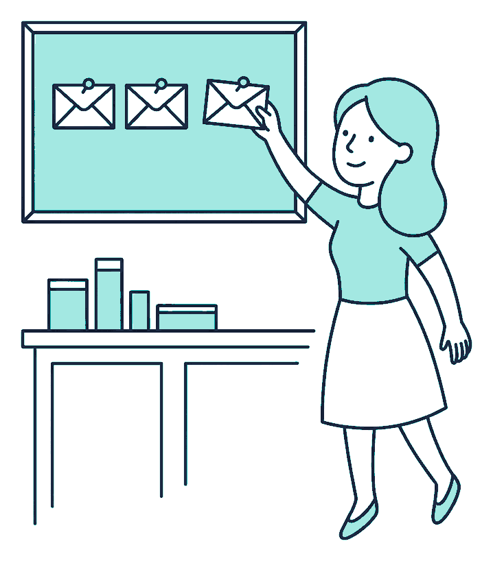 A woman pins three sealed pay envelopes evenly along a corkboard above a tidy kitchen bench