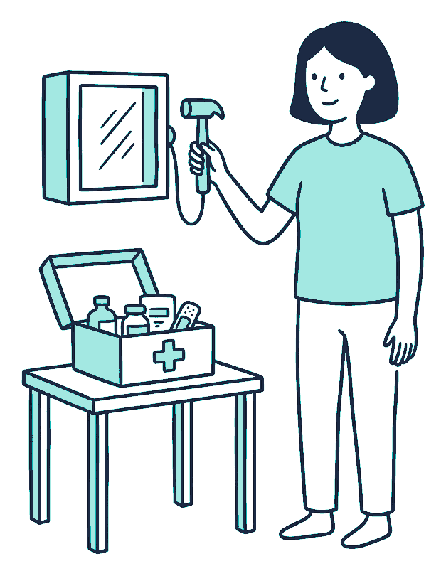 A person with a hammer beside an emergency break-glass box and an open first aid kit